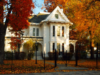 Fall leaves surrounding the pretty white Truman Home, one of the best things to do in Independence, MO