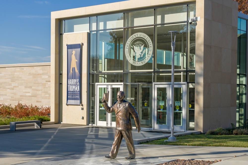 Statue of President Truman outside the glass facade of of the Truman Presidential Library and Museum, one of the best things to do in Independence, MO.