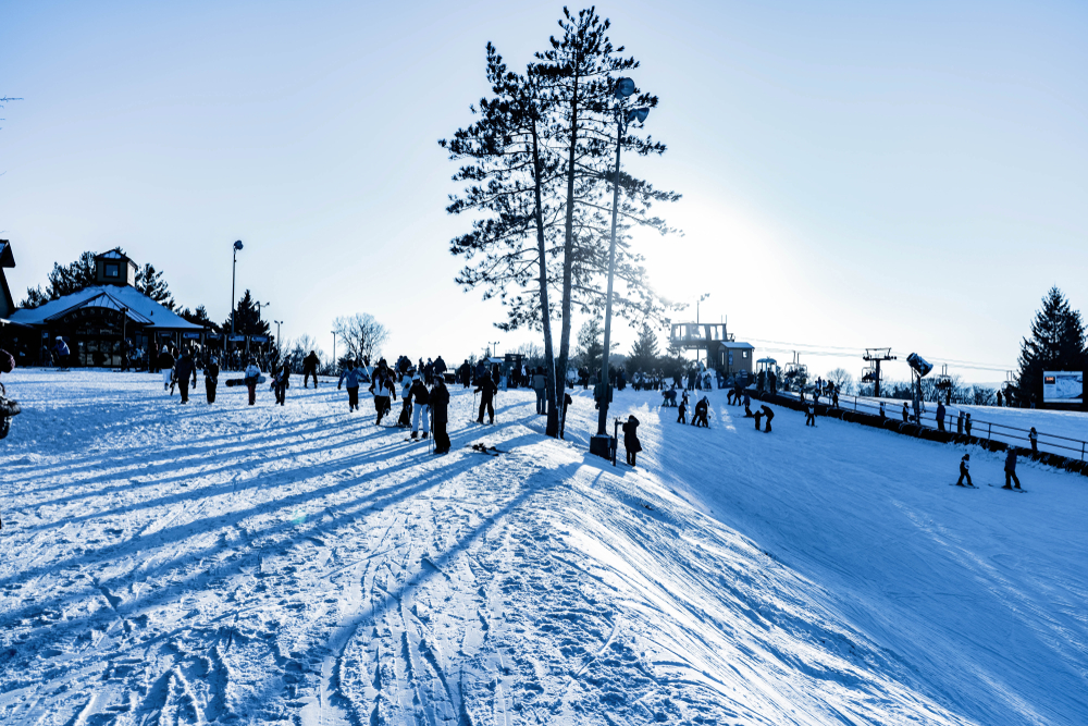 People skiing down a snowy slope at a resort that is one of the best things to do in Galena IL