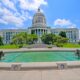 state capitol building in city with a small water pool with statues in front of it things to do in jefferson city mo