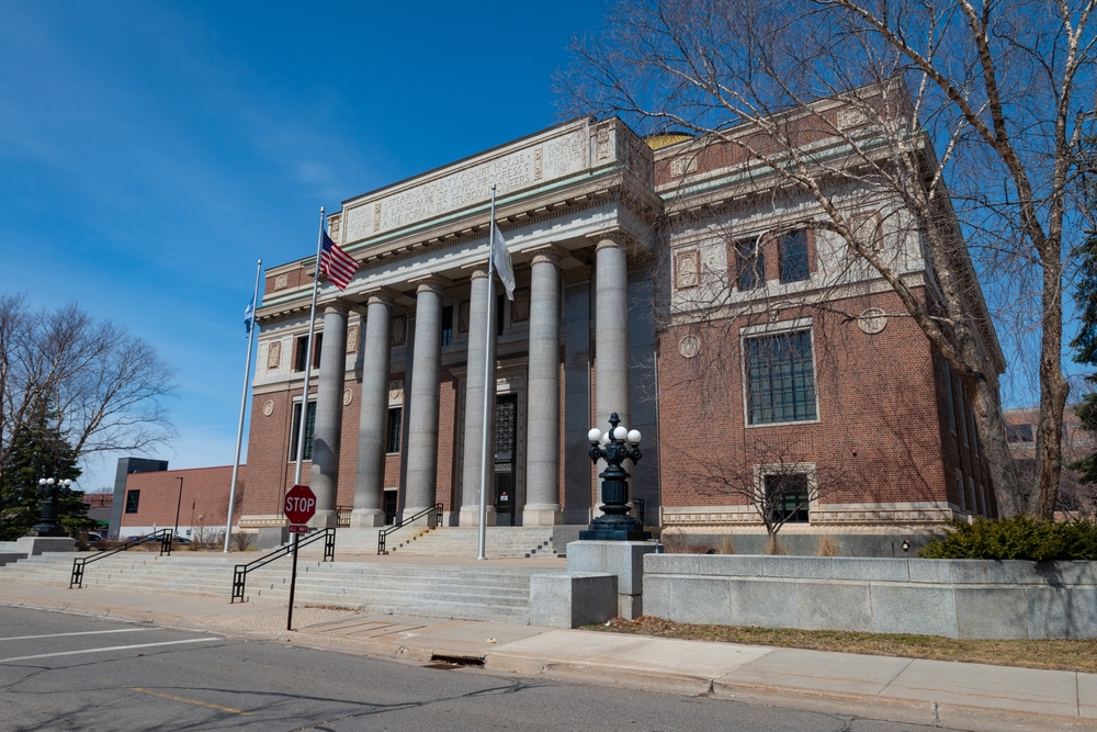 The exterior of the Stearns County Courthouse with brick walls and granite columns.