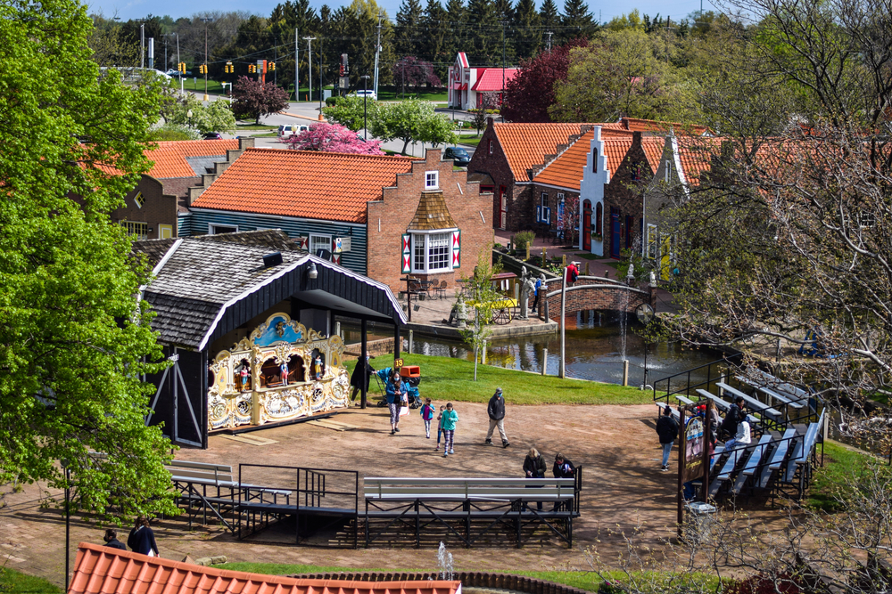 View from the Ferris wheel of Nelis’ Dutch Village with people walking around the Dutch-styled buildings and canals.