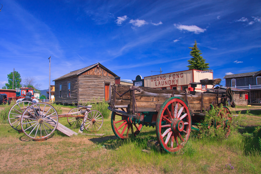 Wagons and log buildings at the World Museum of Mining in Montana.