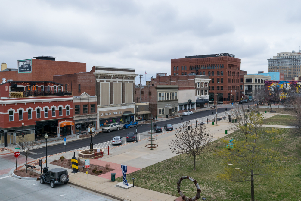 Felix Street Square in downtown St. Joseph. View of cars parked, sculptures, and local business in the background. The article is about the things to do in St Joseph Missouri 