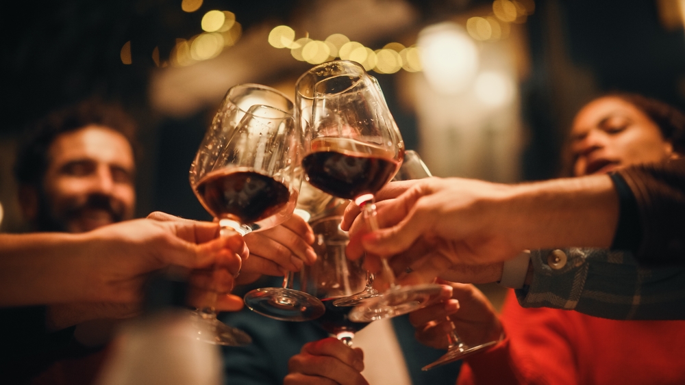 A group of people clinking wine glasses.