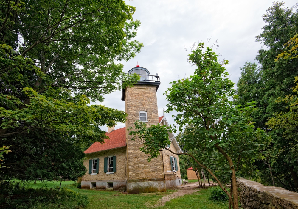 Eagle Bluff lighthouse on Lake Michigan. A brick lighthouse in Door county surrounded by trees. 