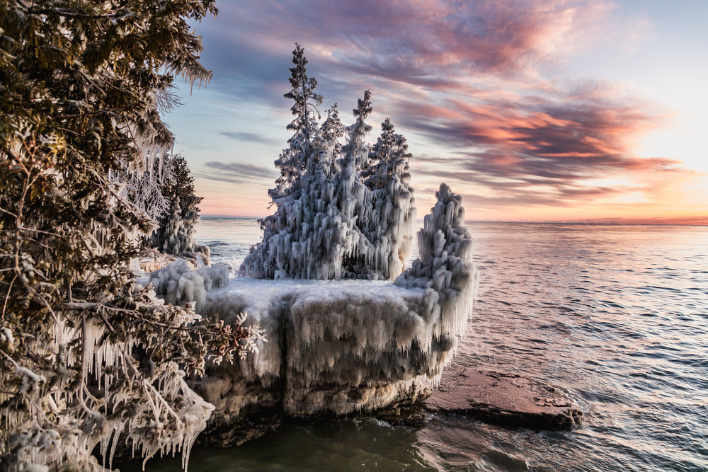 A small peninsula off of an island in the Great Lakes in Door County with trees covered in ice and snow