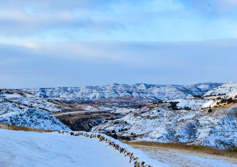 The bridge in the valley is crossing the Little MO river In the Badlands of North Dakota. One of the Midwest winter getaways