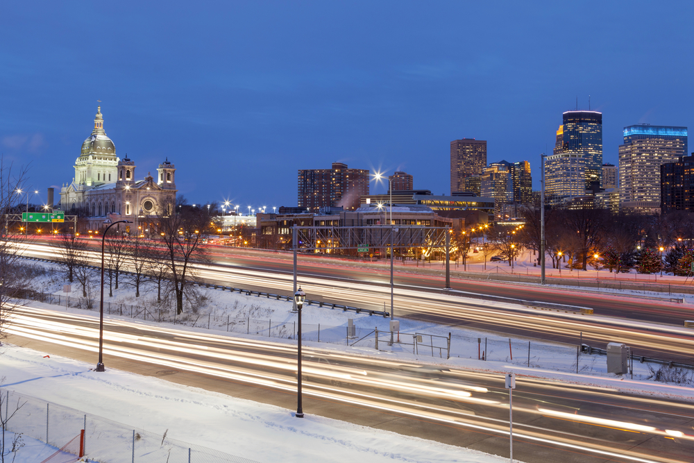  Shot of the Modern and Classical Architecture of the Minneapolis Skyline during Twilight Rush Hour in the snow. One of the Midwest winter getaways