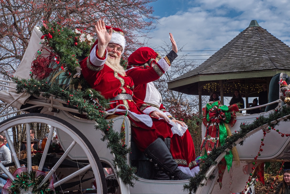 Santa in a carriage waving at the crowds. 