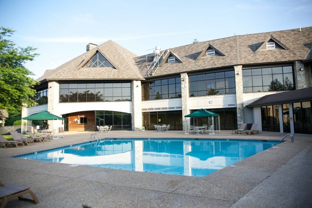 outdoor pool in front of a building with big windows