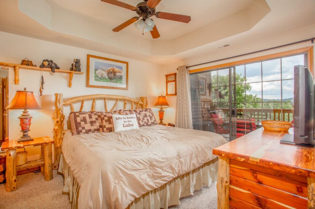 pastel colored room with a window balcony and wooden furnishings branson family resorts