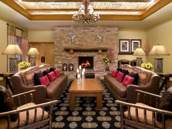 living room with a fireplace and sofas along with chairs branson family resorts