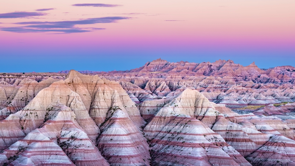 sunset at a national park with colored mountains places to visit in the US before you die