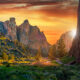 cliffs during sunset surrounded by trees and greenery