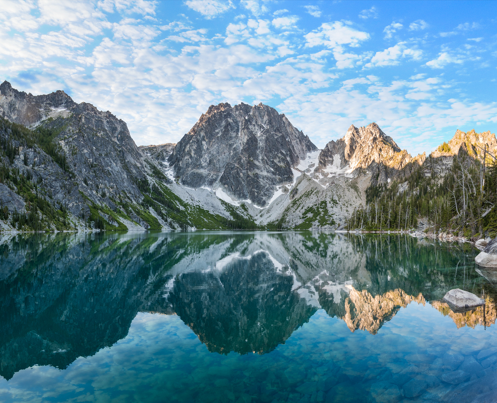 mountains reflecting in the clear lake water places to visit in the US before you die