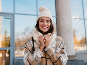 Caucasian woman wearing beige beanie and beige checked coat