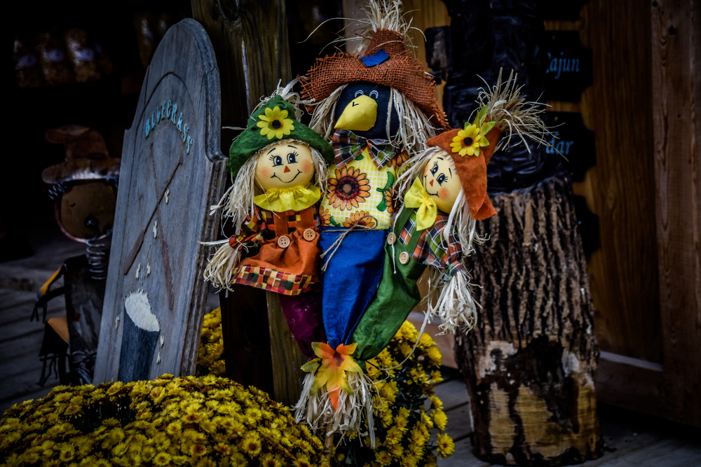 scarecrow decorated with dolls and sunflowers midwest fall festivals