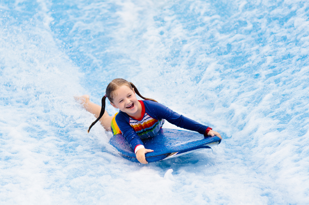 girl surfing on a simulator indoor waterparks in the midwest