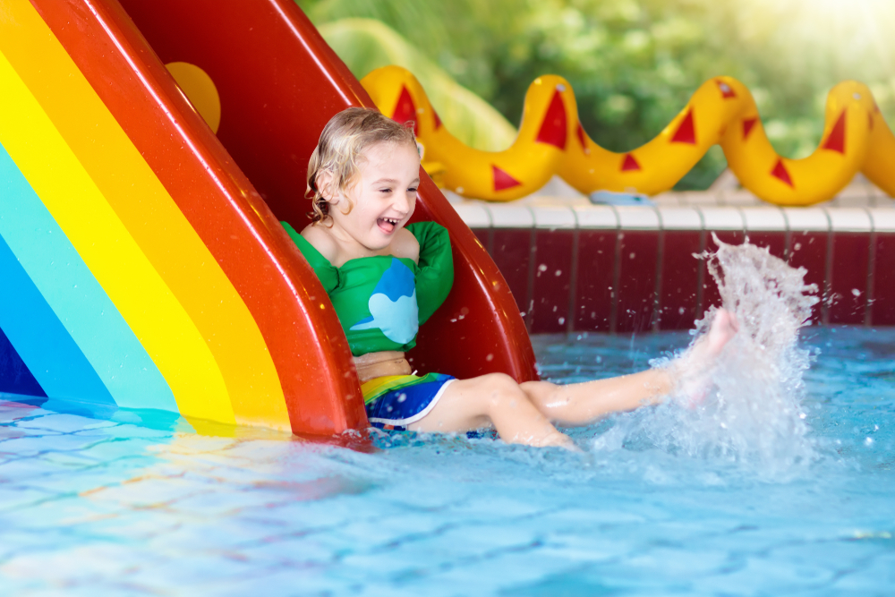 child on a water slide indoor waterparks in the midwest