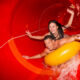 couple inside a covered red water slide indoor waterparks in the midwest