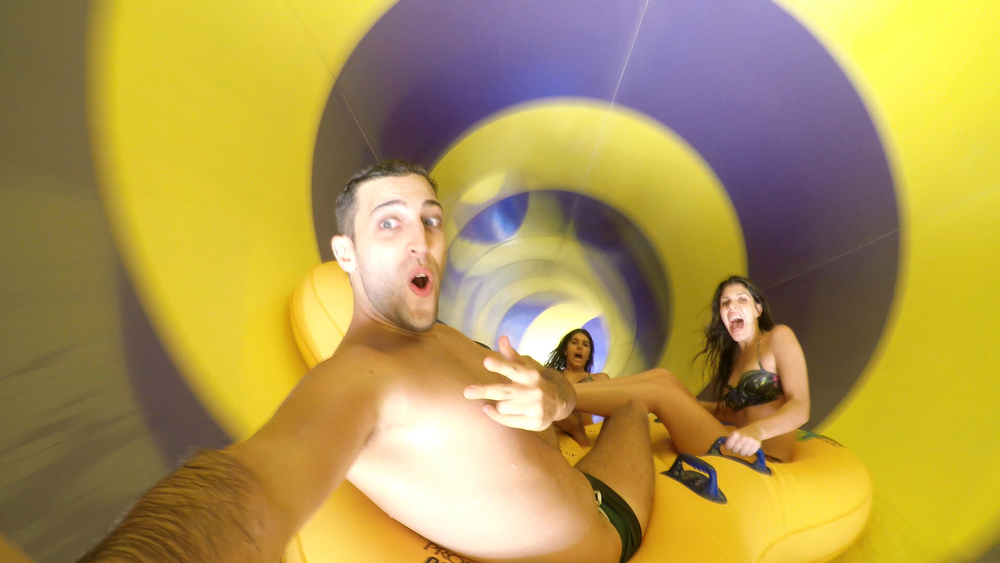 friends enjoying inside a water slide