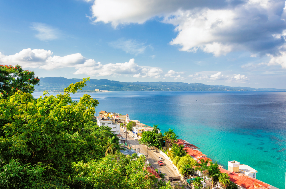view of clean blue ocean with trees on the side
