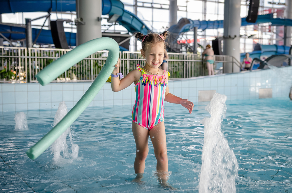 little girl playing inside a waterpark indoor waterparks in the midwest