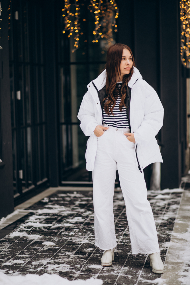 Woman walking outside the street in a winter jacket.