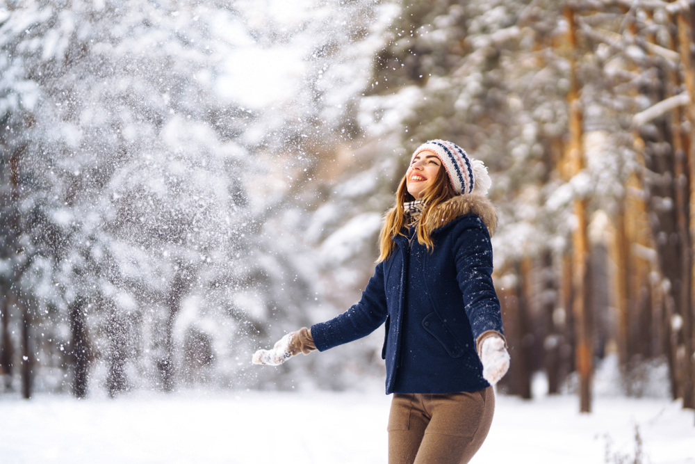 Girl enjoys winter, frosty day. The article is about Montana winter outfits.