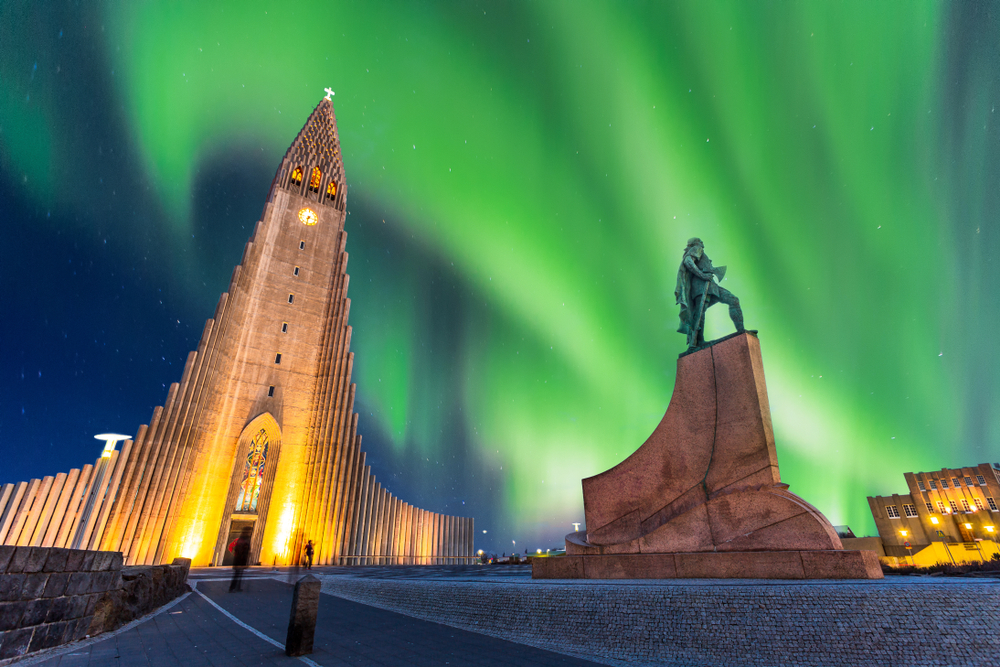 aurora borealis over a church flights from chicago
