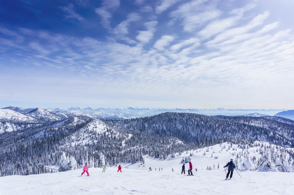 families skiing from a slope all inclusive resorts in montana