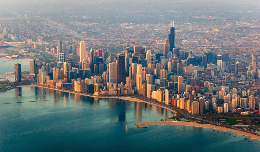 aerial view of the skyline of a city with water beside it