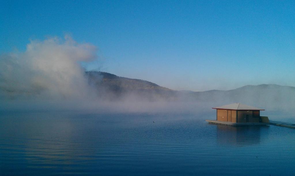 Picture of the lake with mist and you can see the hotel jetty in the picture.