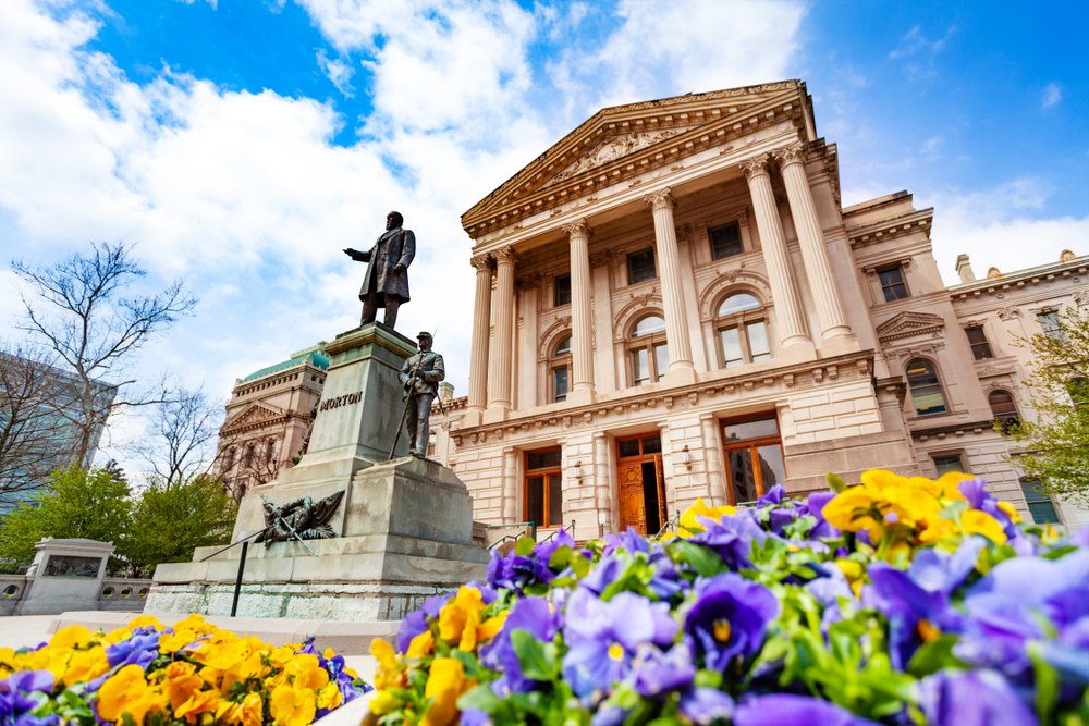Morton statue in front of Indiana Statehouse, USA with flowers in the foreground. 