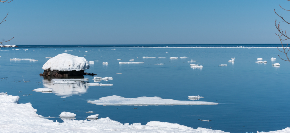 Keweenaw peninsula, Michigan, Lake Superior. You can see snow floating on the lake. The article is about Midwest Winter Road Trips.
