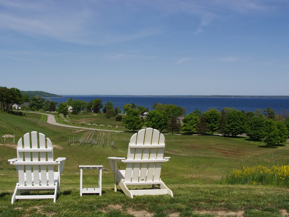 Traverse City Wine Vineyards View. Two chairs looking of the vines and bay