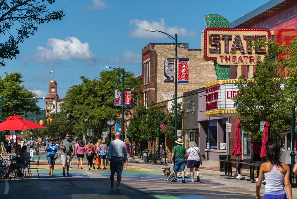  Busy Front Street in downtown with State Street Theater. People are walking down the street. 