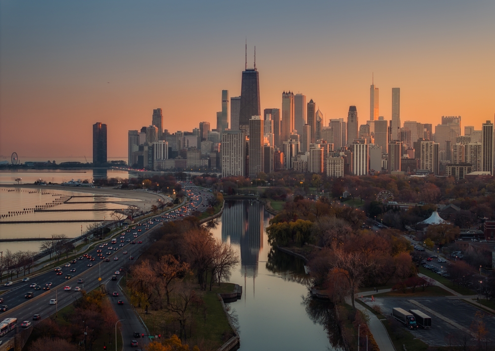 view of a city with skyscrapers during sunset colors best neighborhoods in chicago